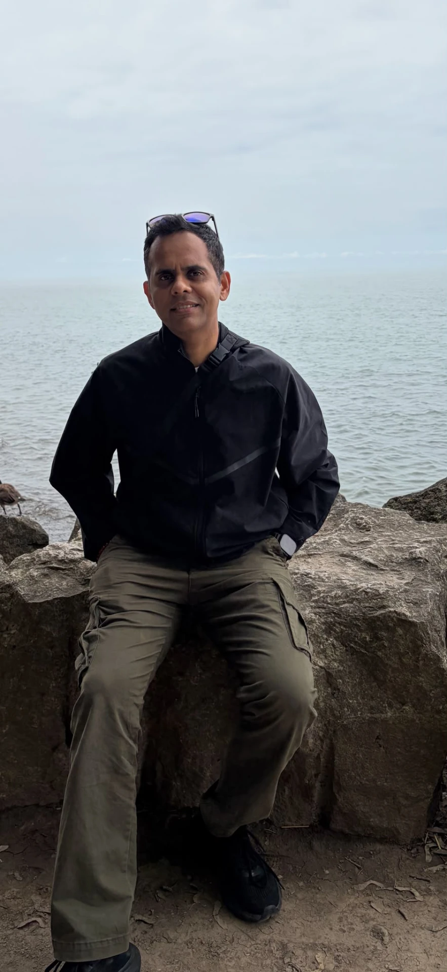 Kartik Iyer standing beside the sea